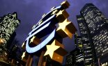The Illuminated euro sculpture is seen in front of the European Central Bank headquarter in Frankfurt.